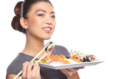 Woman holding sushi with chopsticks clipart