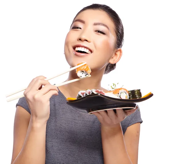 Woman holding sushi with chopsticks — Stock Photo, Image