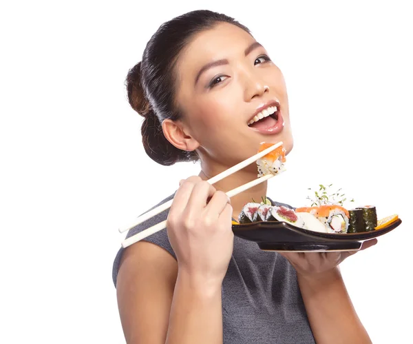 Woman holding sushi with chopsticks — Stock Photo, Image