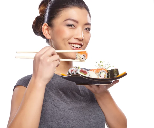 Mujer sosteniendo sushi con palillos —  Fotos de Stock