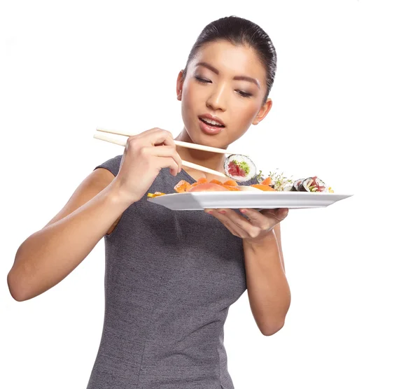 Žena hospodářství sushi hůlkami — Stock fotografie