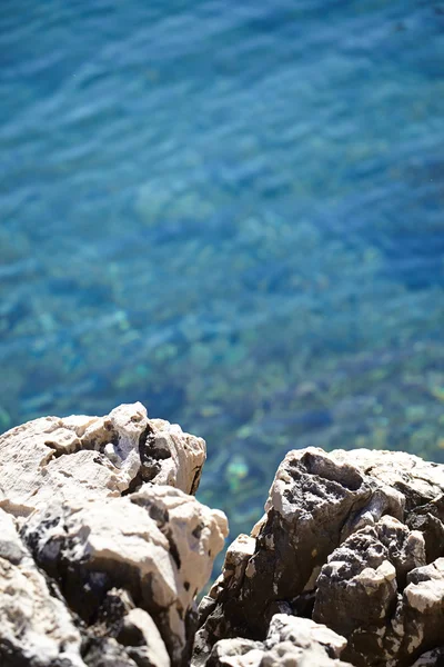 Rocks , sea and blue water background — Stock Photo, Image