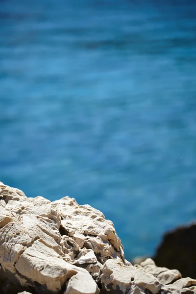 Rocks , sea and blue water background — Stock Photo, Image