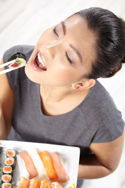 Giovane donna mangiare sushi — Foto Stock