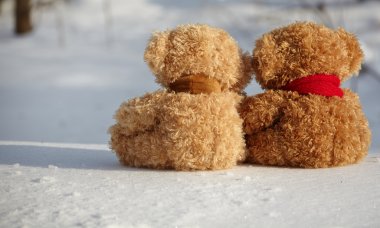 Teddy bears on a snow around each clipart