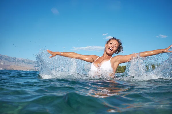 Woman in sea with open hands — Stock Photo, Image