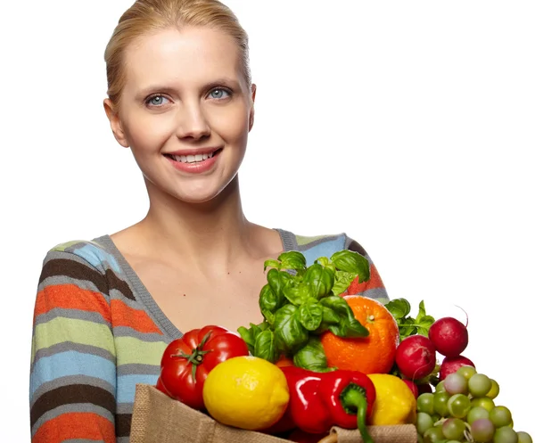 Woman holding a bag full of healthy food — Stock Photo, Image