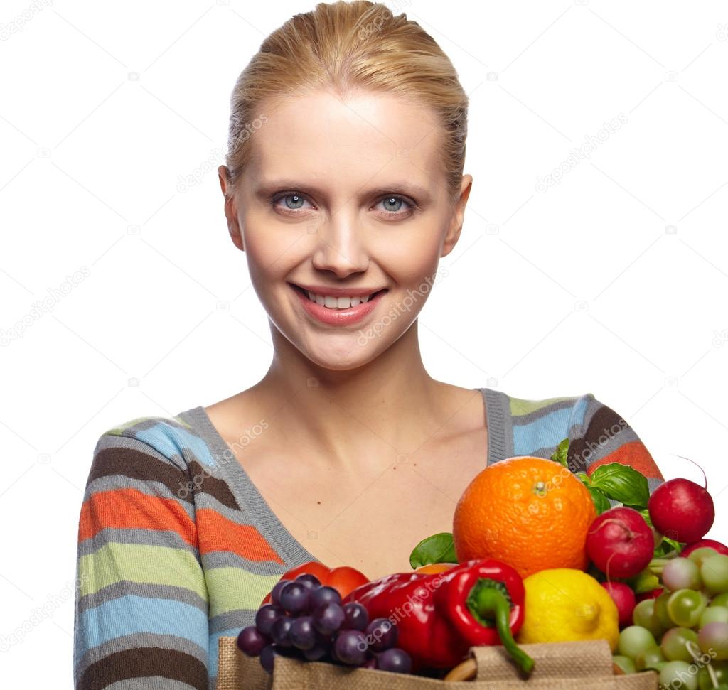 Woman holding a bag full of healthy food