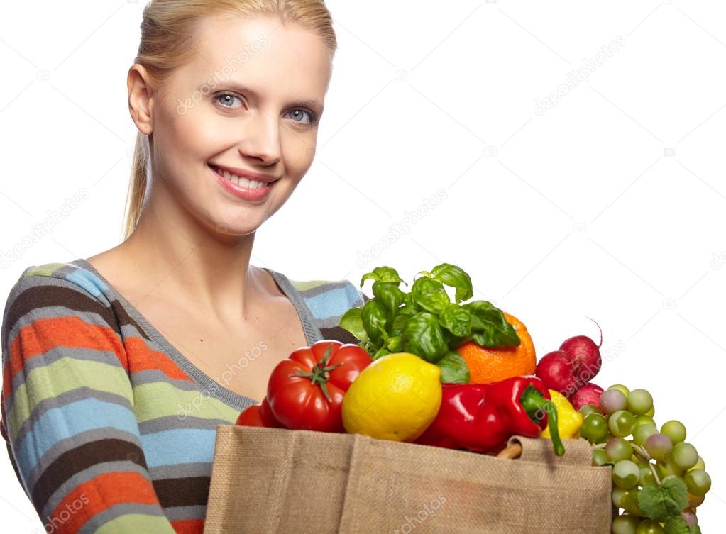 Woman holding a bag full of healthy food