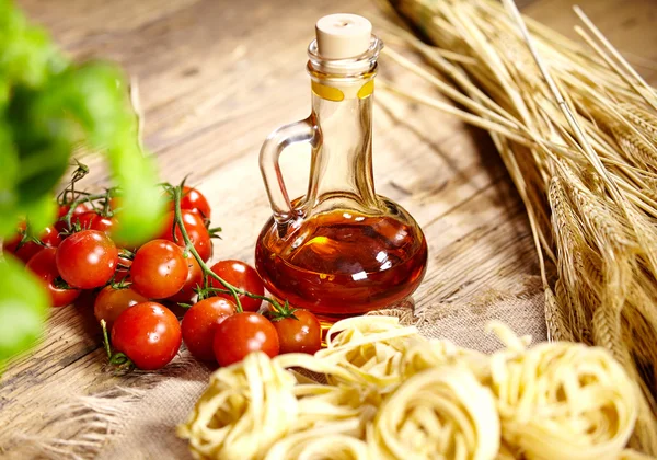 Raw pasta,vegetables ,olive oil and spices — Stock Photo, Image