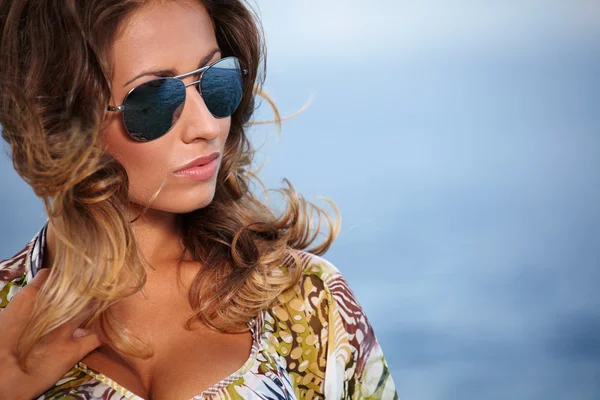 Beautiful girl in dress on the coast Stock Image