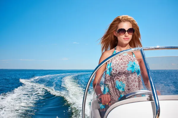 Young girl driving a motor boat Stock Photo