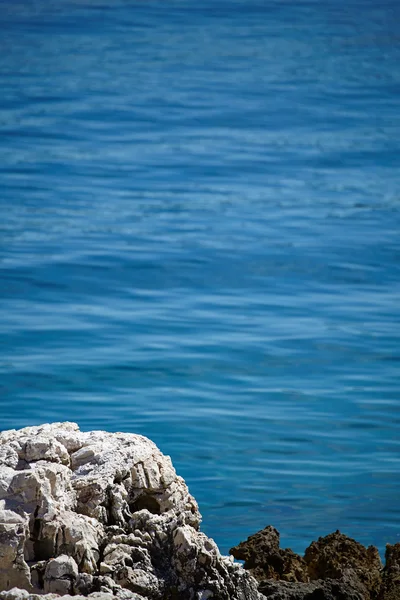 Stones in a blue sea — Stock Photo, Image