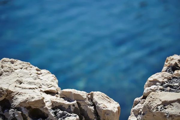 Stones in a blue sea — Stock Photo, Image