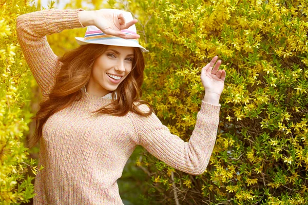 Dívka s kloboukem v parku na jaře — Stock fotografie