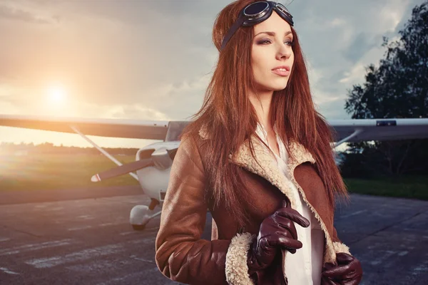 Woman pilot in front of airplane