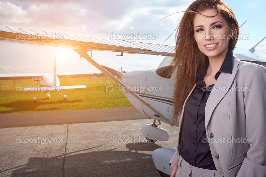 Businesswoman in front of airplane