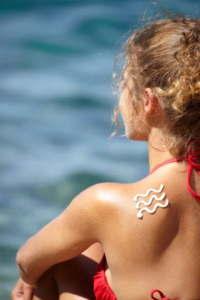 Girl back with sun lotion — Stock Photo, Image