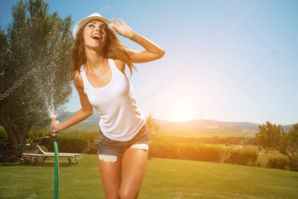 Woman having fun in summer garden