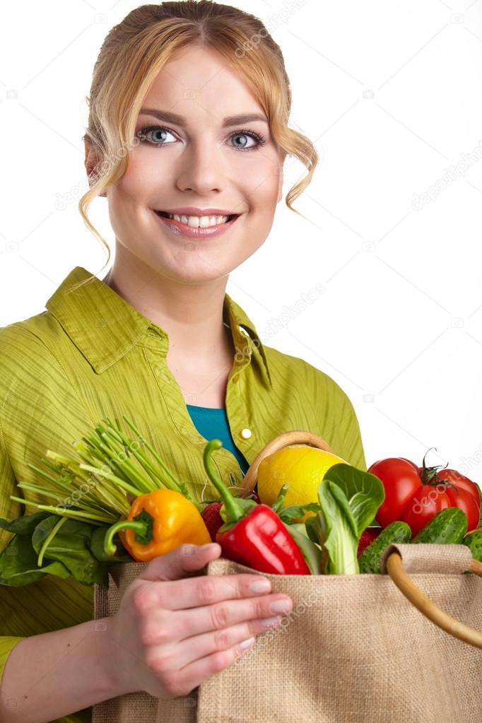 Woman holding shopping bag full of groceries