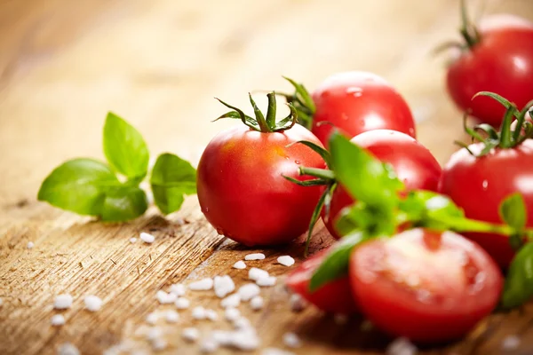 Tomatoes lying on old table — Stock Photo, Image