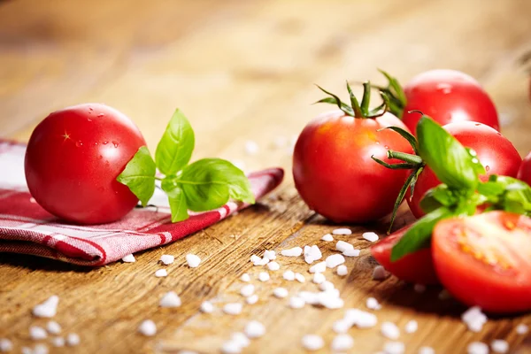 Tomatoes lying on old table — Stock Photo, Image