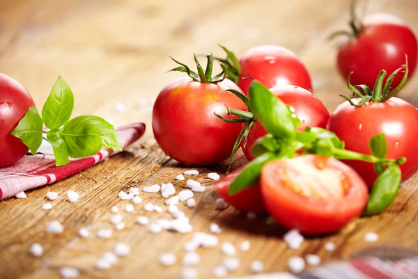 Tomatoes lying on old table — Stock Photo, Image