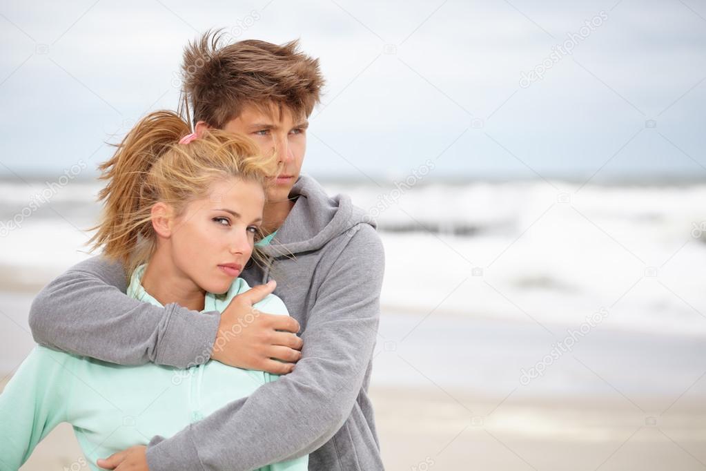 Couple embracing on coast