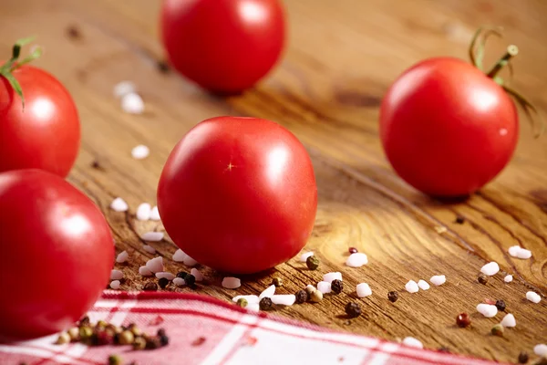 Tomatoes lying on old table — Stock Photo, Image