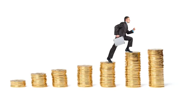 Businessman goes up the gold coins — Stock Photo, Image