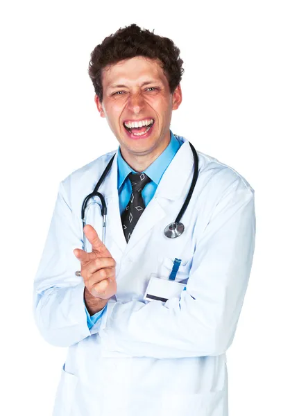 Portrait of a smiling male doctor showing finger at you on white — Stock Photo, Image