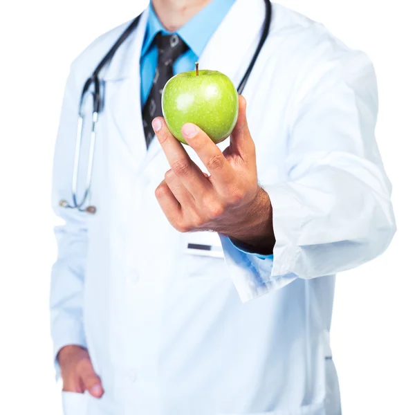 Mano del doctor sosteniendo un primer plano de manzana verde fresca —  Fotos de Stock