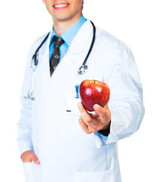 Lekarz trzymając czerwony jabłko na biały z bliska — Zdjęcie stockowe