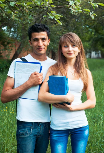 Two students in park with book outdoors — Stock Photo, Image