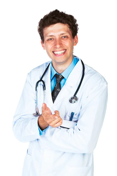 Portrait of a smiling male doctor showing finger at you on white — Stock Photo, Image