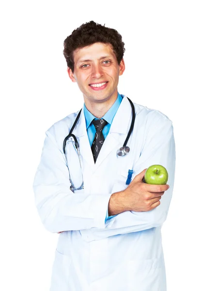 Retrato de un médico varón sonriente sosteniendo manzana verde sobre blanco —  Fotos de Stock