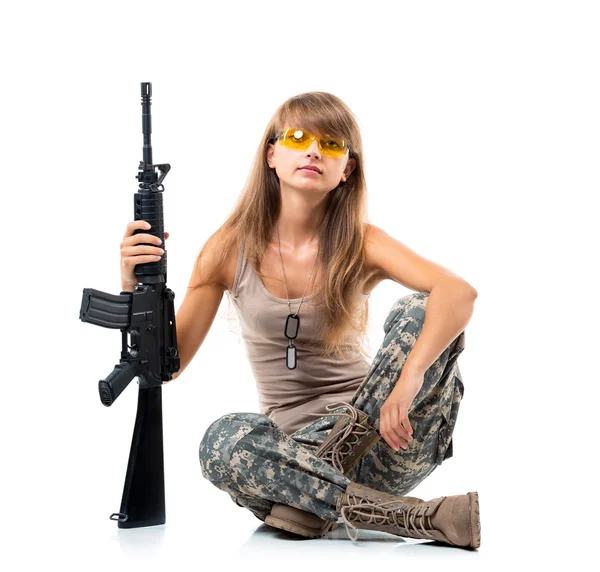 Soldier young beautyful girl dressed in a camouflage with a gun — Stock Photo, Image