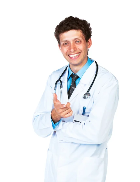 Portrait of a smiling male doctor showing finger at you on white — Stock Photo, Image