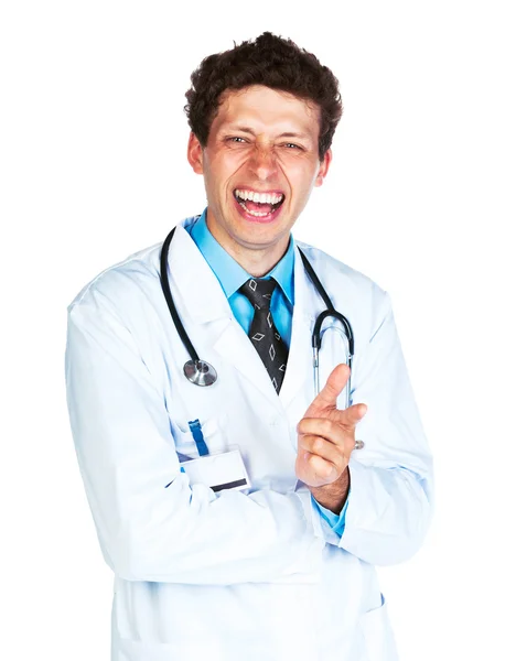 Portrait of a smiling male doctor showing finger at you on white — Stock Photo, Image