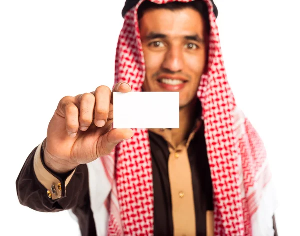 Young smiling arab showing business card in hand isolated on whi — Stock Photo, Image