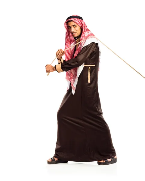 Young Arab pulling a rope isolated on white — Stock Photo, Image