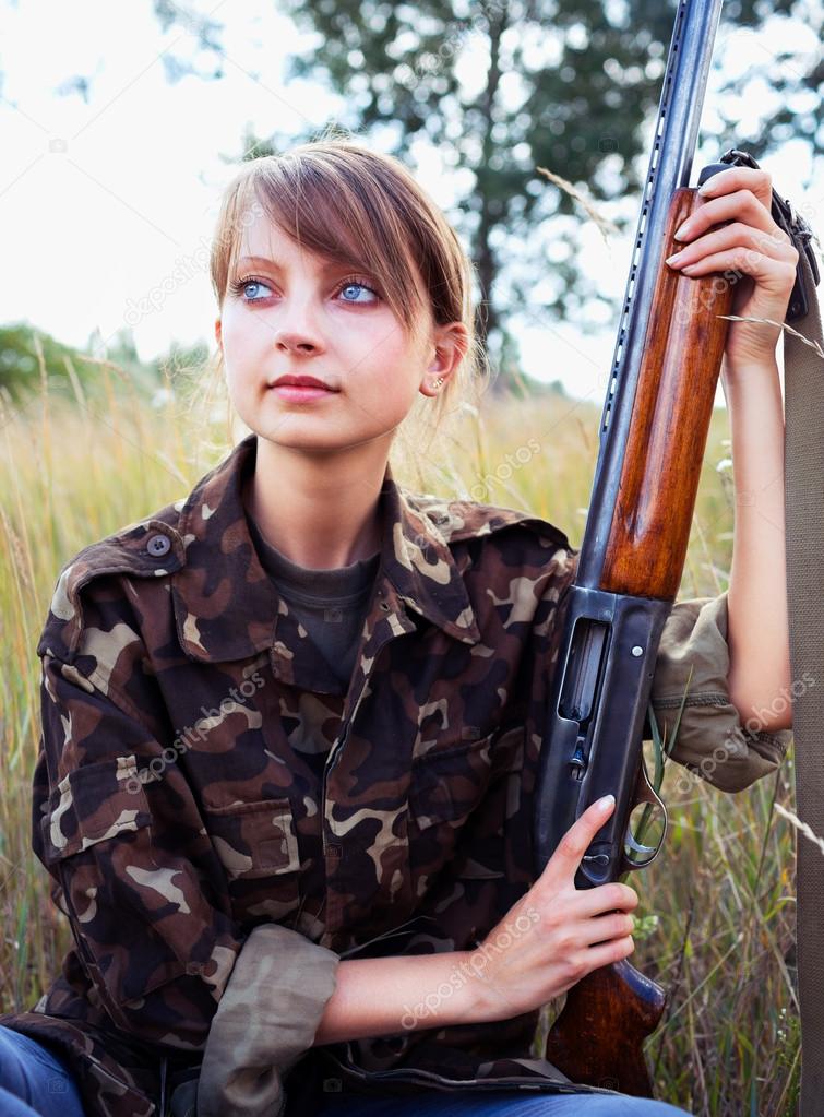 Young beautiful girl with a shotgun