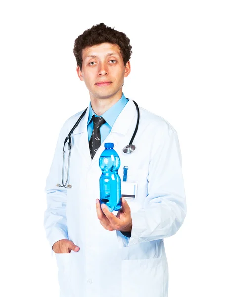 Portrait of a male doctor holding bottle of water on white — Stock Photo, Image