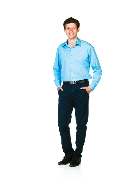 Happy young businessman standing with his hands in pockets on wh — Stock Photo, Image