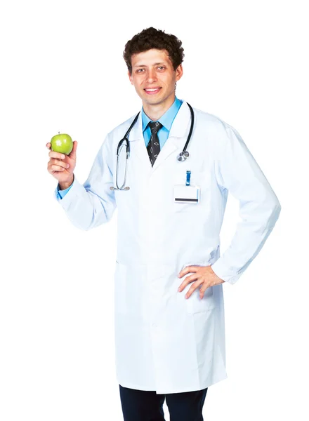 Retrato de un médico varón sonriente sosteniendo manzana verde sobre blanco —  Fotos de Stock