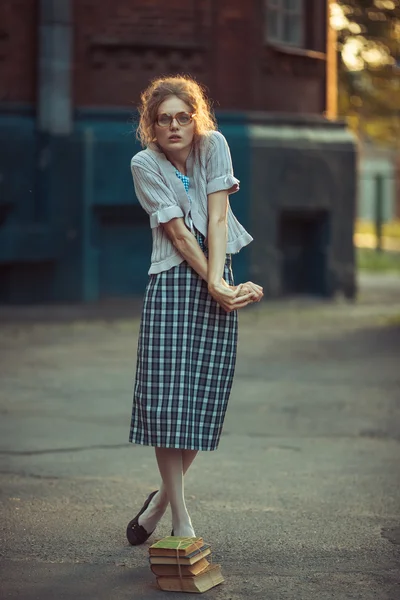 Funny girl with glasses and a vintage dress