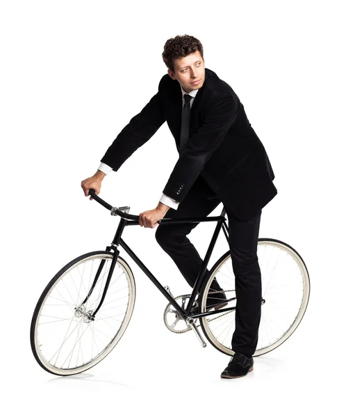 Attractive man in a classic suit with a bicycle on a white — Stock Photo, Image