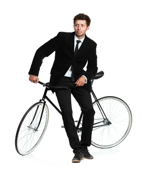 Attractive man in a classic suit with a bicycle on a white — Stock Photo, Image