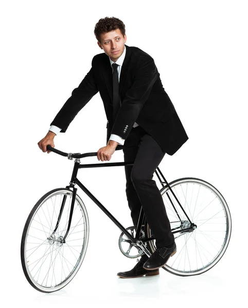 Attractive man in a classic suit with a bicycle on a white — Stock Photo, Image