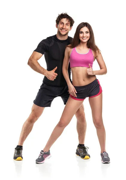 Athletic man and woman after fitness exercise on the white — Stock Photo, Image
